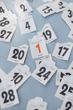 Torn calendar page showing first of May among other dates
