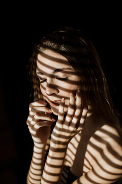 Intimate portrait with striking light and shadow pattern