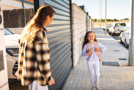 Mother welcoming daughter returning from school