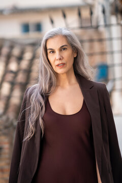 Confident mature woman with grey hair outdoors