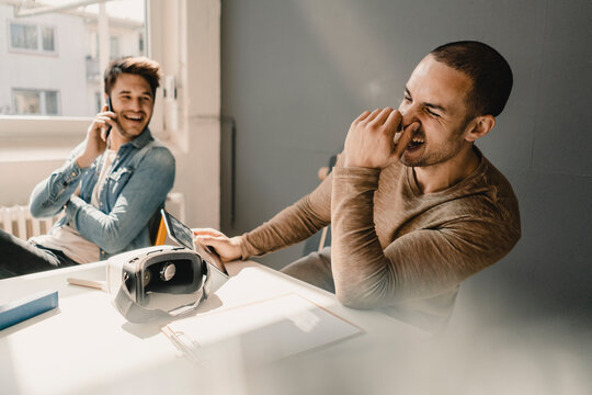 Young business people working together iin office, talking on the phone