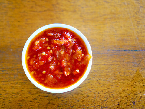 Traditional Indonesian sambal ulek made from freshly crushed red chili peppers, served in a small bowl with a rich spicy flavor