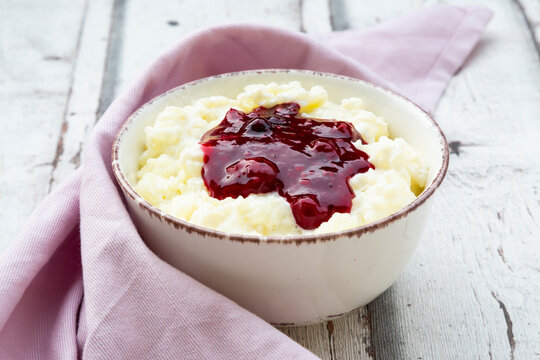 Bowl of rice pudding with cherry and berry groats