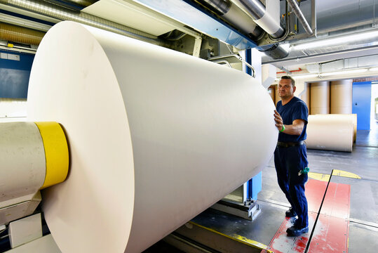 Man working at printing machine in a printing shop