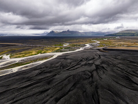 Bridge over glacial rivers and volcanic sediment in Iceland