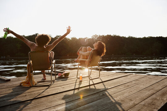 Germany, Berlin, Young couple relaxing on chairs