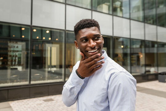 Thoughtful smiling man with hand on chin