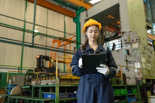 Portrait engineer woman or worker smile and use clipboard checking machine in warehouse for production supply