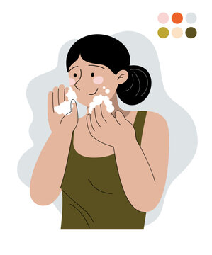 Woman washing face with foam facial cleansing routine