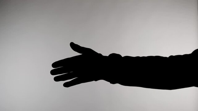 An anonymous silhouette of a man stands against a white background and extends his hand to say hello