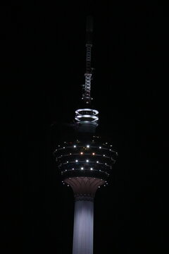 KL Tower Illuminated at Night Against a Dark Sky