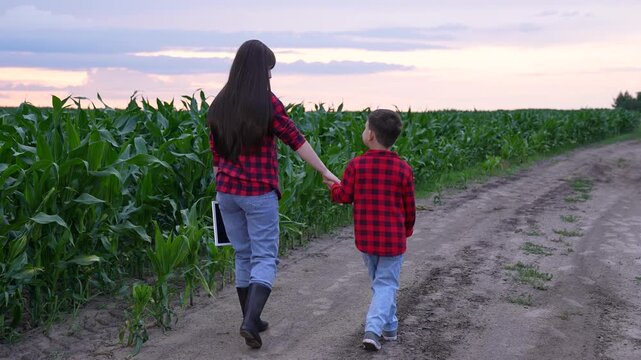 mother child holding hands, happy people woman child, Journey through nature with family, Little boy guided by his mom, Mother and son on a dirt road, Experiences in rural America, Farm life