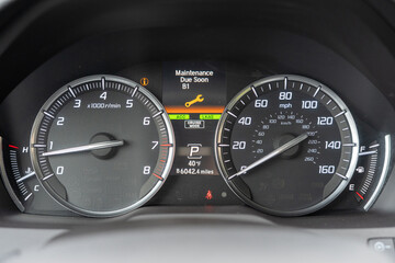Fototapeta premium Car dashboard display showing Maintenance Due Soon B1 service alert message with yellow wrench icon