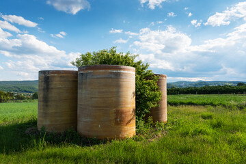 Obraz premium Rainwater storage tank in the green field