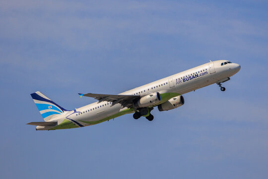 Fukuoka Japan - 2025 April 26: An Air Busan Airbus A321-200 passenger aircraft with registration HL7728 climbing into the blue sky while retracting its landing gear after takeoff from Fukuoka Airport.