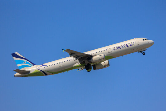 Fukuoka Japan - 2025 April 26: An Air Busan Airbus A321-200 passenger aircraft with registration HL7728 climbing into the blue sky while retracting its landing gear after takeoff from Fukuoka Airport.