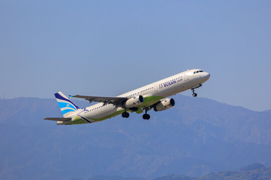Fukuoka Japan - 2025 April 26: An Air Busan Airbus A321-200 passenger aircraft with registration HL7728 climbing into the blue sky while retracting its landing gear after takeoff from Fukuoka Airport.