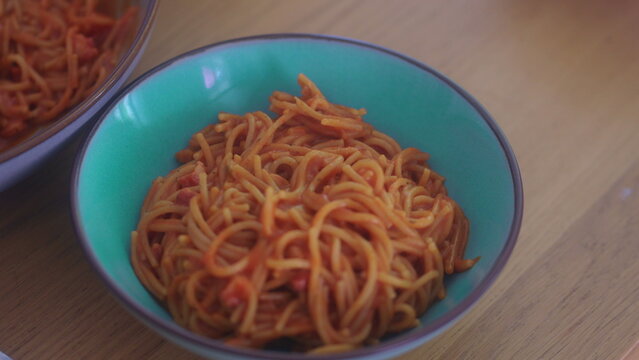 Fresh spaghetti served in bowl on dining table during family mealtime capturing homemade comfort food and authentic everyday home dining atmosphere