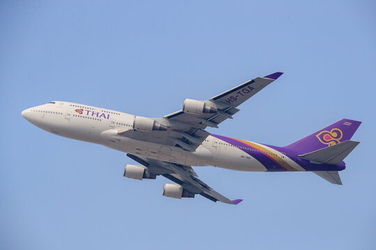 Chek Lap Kok, Hong Kong Japan - 2018 January 23: A Thai Airways International Boeing 747-400 passenger aircraft with registration HS-TGA climbing into the sky after takeoff from Hong Kong Internationa