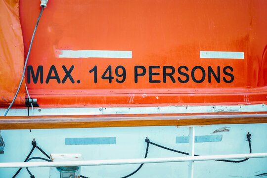 Maximum Capacity Safety Sign on Orange Cruise Ship Lifeboat Tender