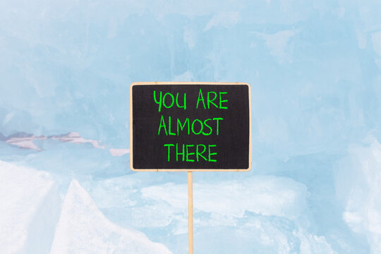 You are almost there words symbol. Concept words You are almost there on beautiful black blackboard. Beautiful ice background. Business You are almost there motivational support concept. Copy space.