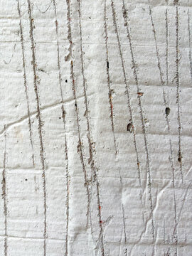 Textured concrete wall surface with grid pattern and scratches
