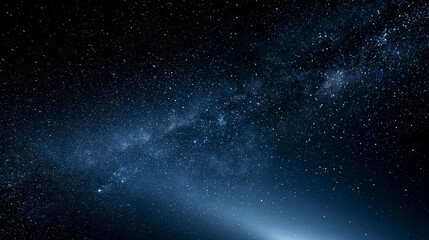 Obraz premium Stunning Milky Way panorama in deep blues and blacks, with glowing stardust, cosmic dust lanes and scattered twinkling stars forming a dreamy, infinite celestial background