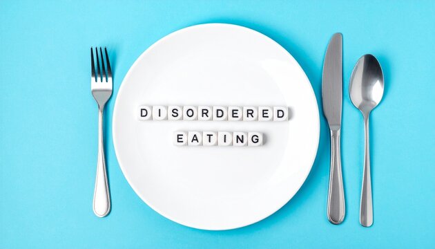 Concept of Disordered Eating Spelled Out on Dinner Plate with Fork and Knife