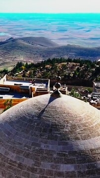Vertical video of Abdullatif (Latifiye) Mosque dome in Mardin, Turkey. Showcasing Islamic architecture, stone craftsmanship, cultural heritage, and the city's historic atmosphere.
