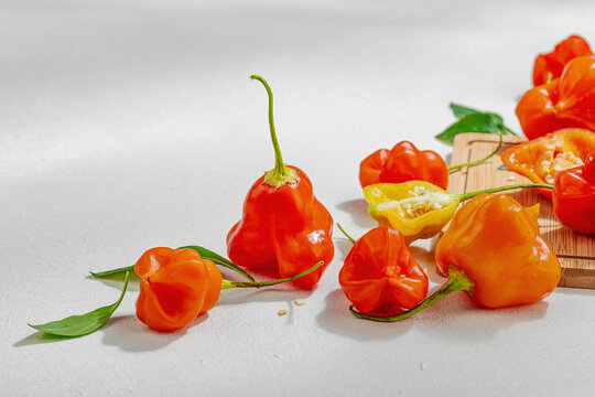 Culinary background of assorted fresh chili peppers arranged on a wooden cutting board