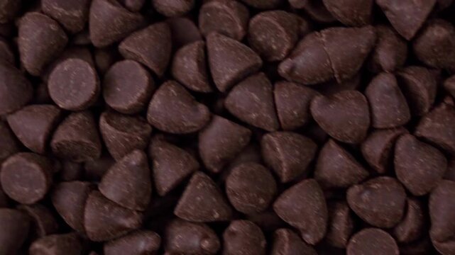 Top down full frame tracking shot of chocolate baking chips texture