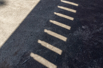 Fototapeta premium Shadow Pattern From Wall Openings on Rough Concrete Surface Background