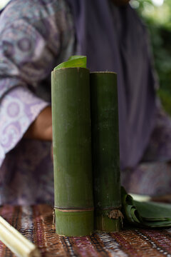 Traditional Southeast Asian lemang made of glutinous rice and coconut milk cooked inside green bamboo sticks, a popular festive dish for Hari Raya celebrations