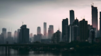 Fototapeta premium A blurred atmospheric cityscape silhouette of tall buildings against the twilight sky