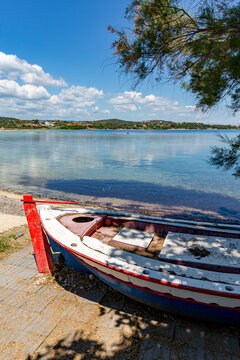 Boat that is sitting on the shore of the water, Ammoulliani, Greece