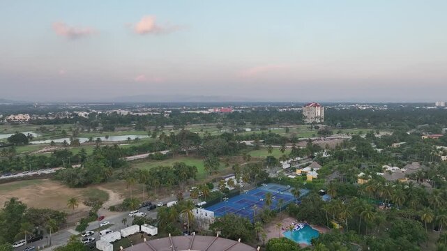 Aerial wide view of a luxury golf course with lakes and mountains in Acapulco Diamante, Mexico