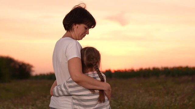 mother woman parent female, child girl kid childhood outdoors, Mother and daughter watching sunset, Family love and bonding, Peaceful evening embrace, Parent and child outdoors, Warm hug at sunset