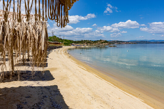 Beach with a bunch of straw umbrellas on it, Ammoulliani, Greece