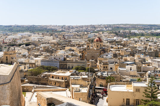View of the traditional limestone architecture and the parish church dome in the town of Zebbug, Gozo Region, Malta.