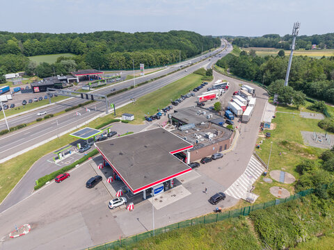 30 May 2026, Rotselaar, Belgium. Aerial drone view of highway service area with truck parking, EV charging and traffic on E314 motorway