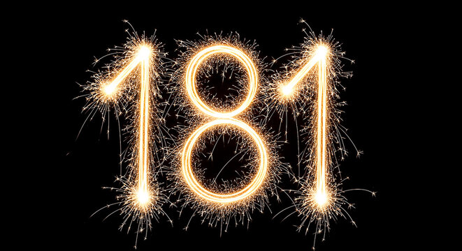 Vibrant sparklers forming the year '181' in bright golden light against a black backdrop, evoking celebration and festivity.