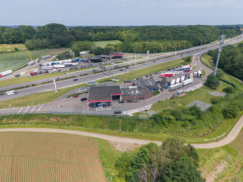 30 May 2026, Rotselaar, Belgium. Wide aerial drone view of highway service area with truck congestion and traffic flow on E314 motorway