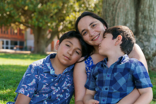 Mother and two sons resting outdoors