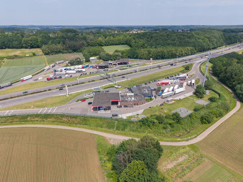30 May 2026, Rotselaar, Belgium. Large-scale aerial drone view of highway service area with logistics traffic and truck congestion on E314 motorway