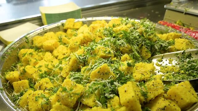 Dhokla is a soft steamed Gujarati snack made from fermented batter with a light tangy flavor