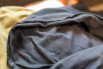 Fototapeta premium Close-up of soft, wrinkled fabrics in different shades of gray and beige, perfect for textile design, fashion design, or home decor concepts.