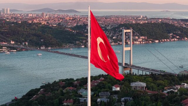 Istanbul Sunset with Turkish Flag, Ortakoy Mosque and 15 July Martyrs Bridge &ndash; Cinematic Smooth Drone Flight Over the Bosphorus
