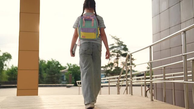 child goes to class holding book hand, educational program, child kid first grader holding book hands runs class, child goes school, child school backpack goes educational classes, child kid carries