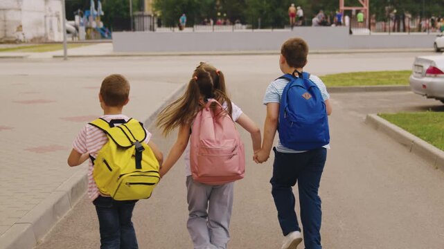 Back to School Together, Happy Kids Walking to School, Children with Backpacks on the Way, First Day of School Adventure, Group of Friends Going to School, Kids Holding Hands on the Street