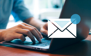 Naklejka premium Email communication and digital messaging on laptop keyboard.